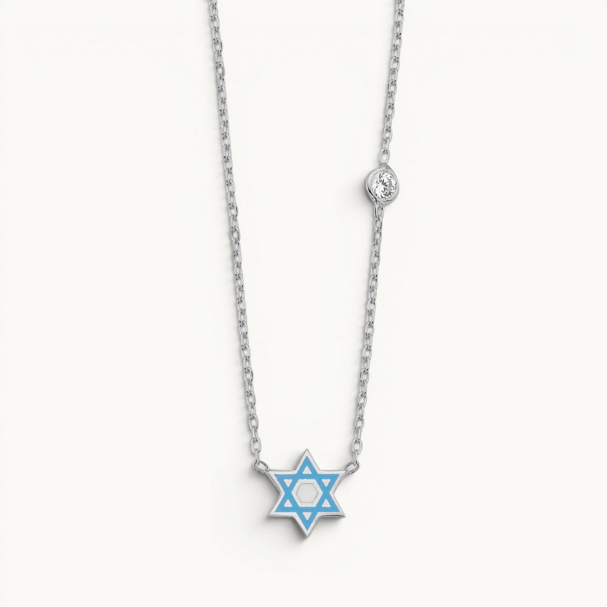 Star of David necklace in sterling silver with blue enamel and bezel-set cubic zirconia by Alef Bet