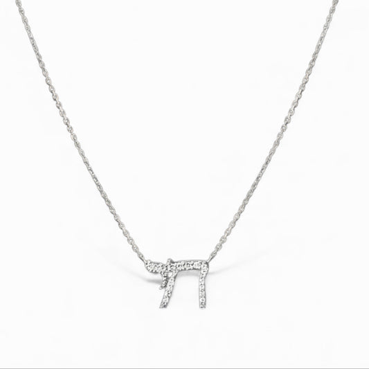 Silver necklace with a small pendant on a white background