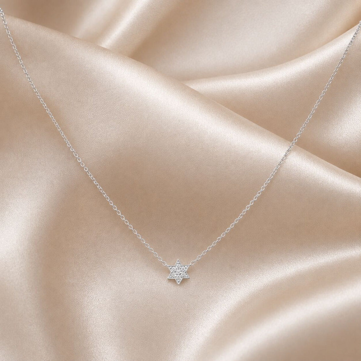 Star of David pendant in yellow gold with diamond pave setting, overhead view by Alef Bet