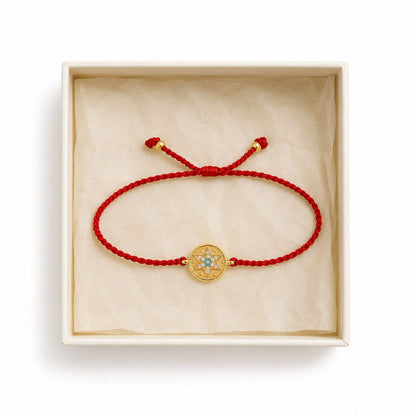 Red string bracelet with adjustable silver star accent shown from side angle by Alef Bet