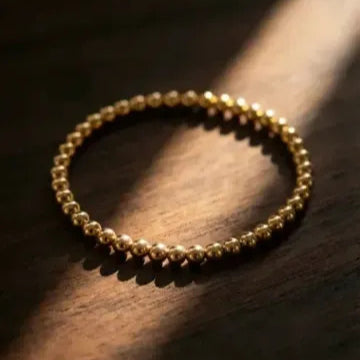 Yellow gold 5mm beaded bracelet showcasing spherical bead details by Alef Bet