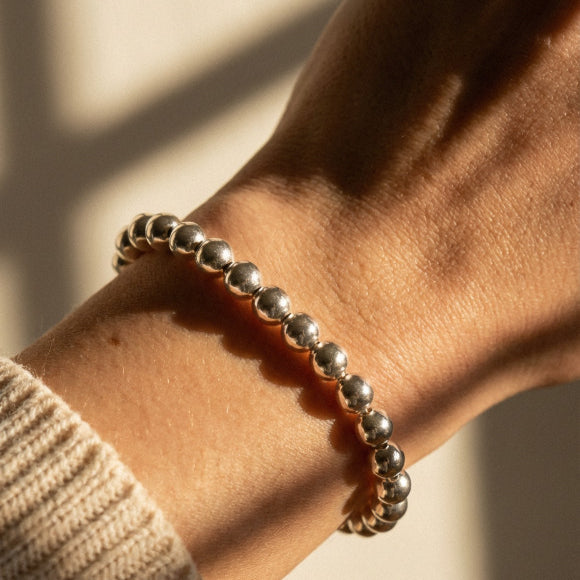 Sterling silver 6mm bead bracelet displaying uniform sphere construction by Alef Bet