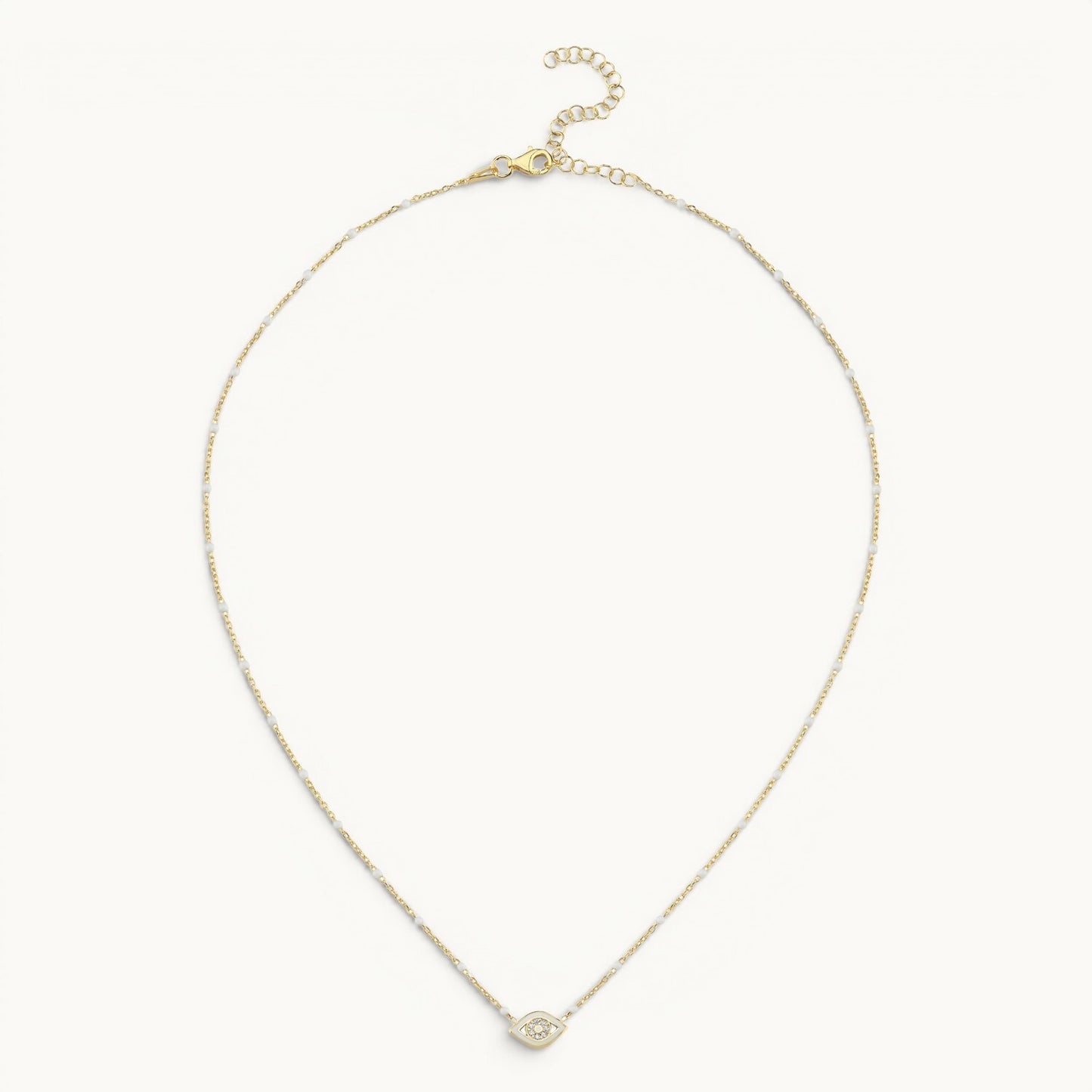 Evil eye pendant in yellow gold with white enamel and pave diamond accents by Alef Bet