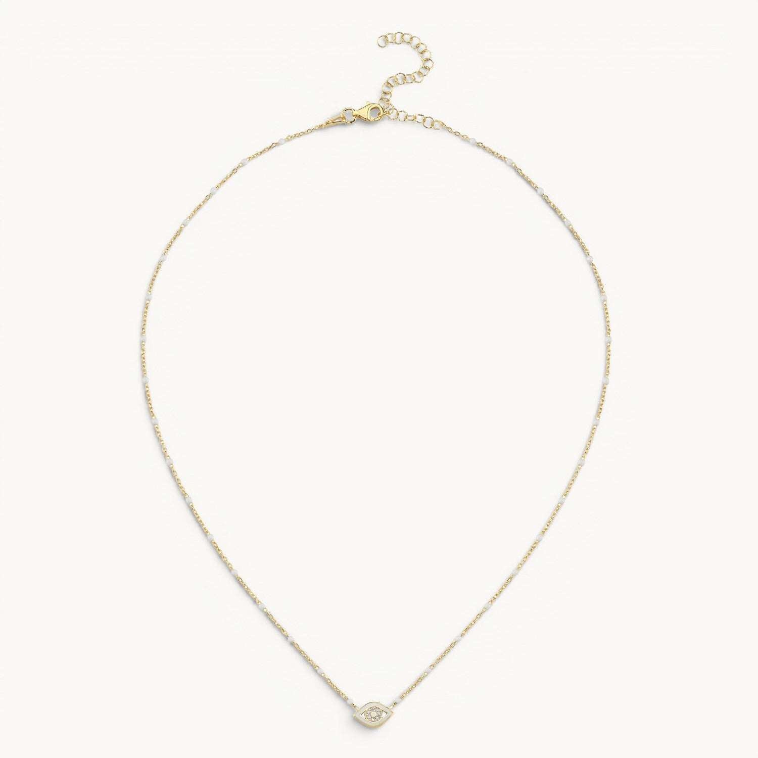 Evil eye pendant in yellow gold with white enamel and pave diamond accents by Alef Bet