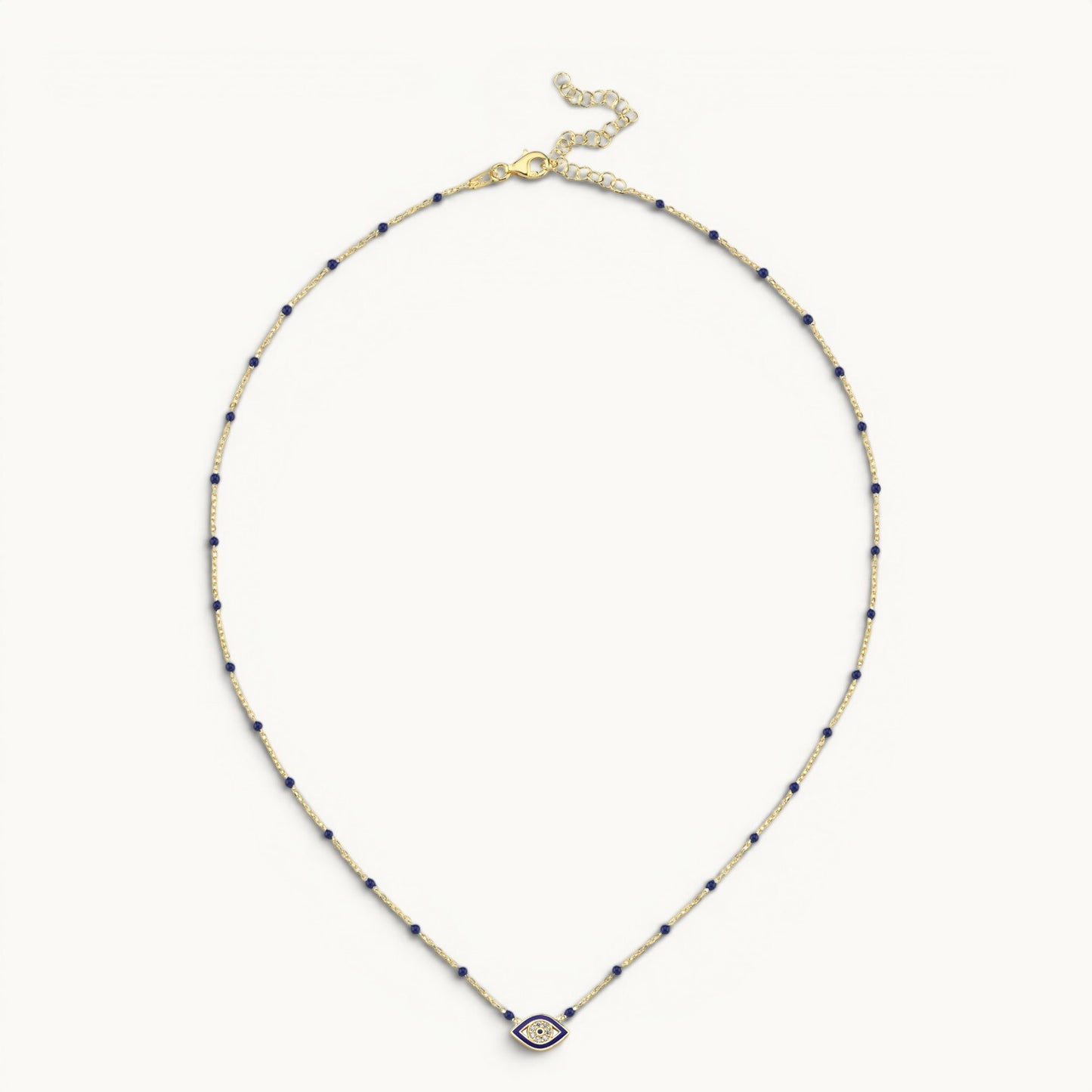 Evil eye pendant in yellow gold with navy enamel by Alef Bet