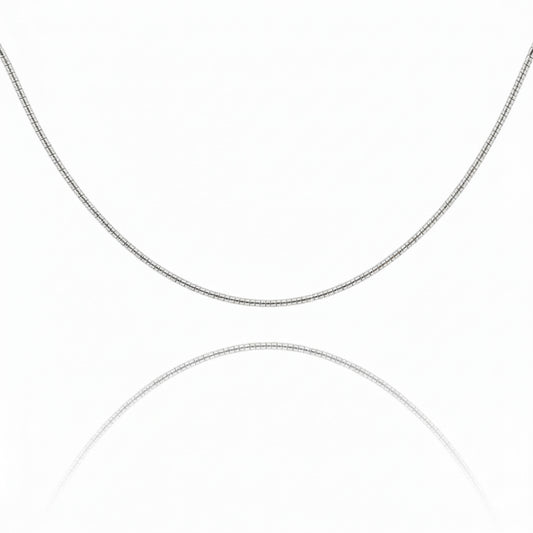 A vibrant sunset over a serene lake with silhouettes of trees, reflecting warm colors on the water's surface.