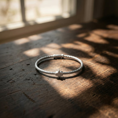 Hamsa bangle bracelet in silver with bezel-set gemstone accent detail by Alef Bet