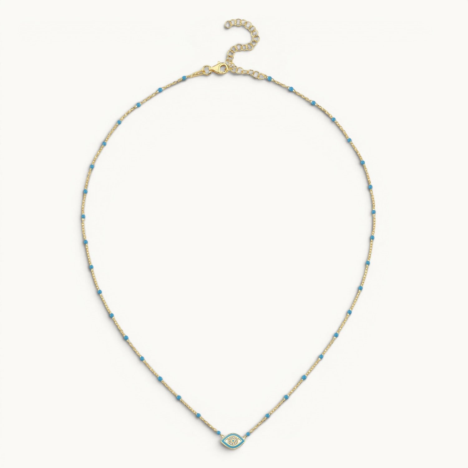 Enamel evil eye pendant in light blue with yellow gold plating by Alef Bet