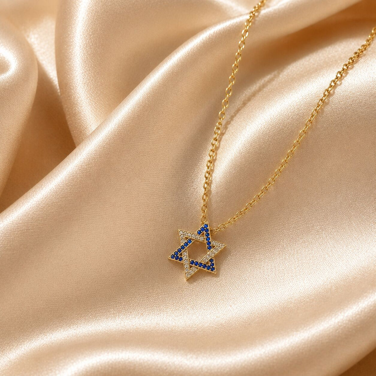 Gold-plated silver necklace featuring the Star of David, embellished with blue and white cubic zirconia, symbolizing Israeli pride.