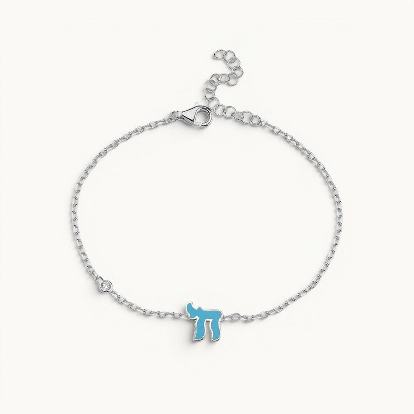 Chai Hebrew bracelet featuring sparkling pink or blue cubic zirconia, crafted in sterling silver or 14k gold plated, symbolic of life.