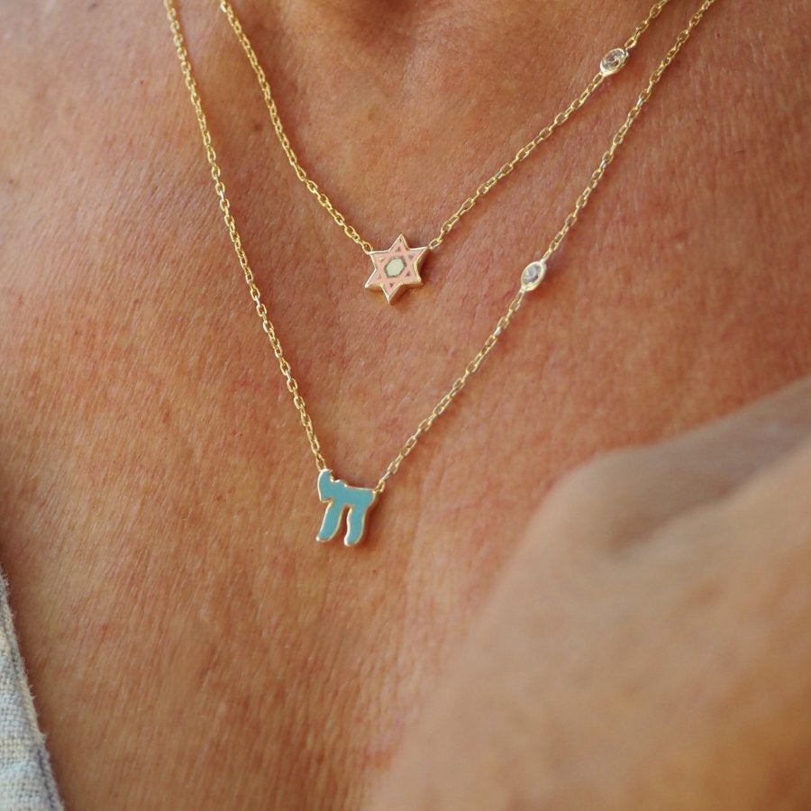 Chai Hebrew necklace featuring a sparkling pink or blue cubic zircon gemstone, available in sterling silver or gold plated. Perfect Bat Mitzvah gift!