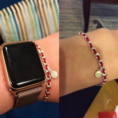 A sterling silver Chai charm bracelet with a red string for good luck and protection, includes a description card of its significance.