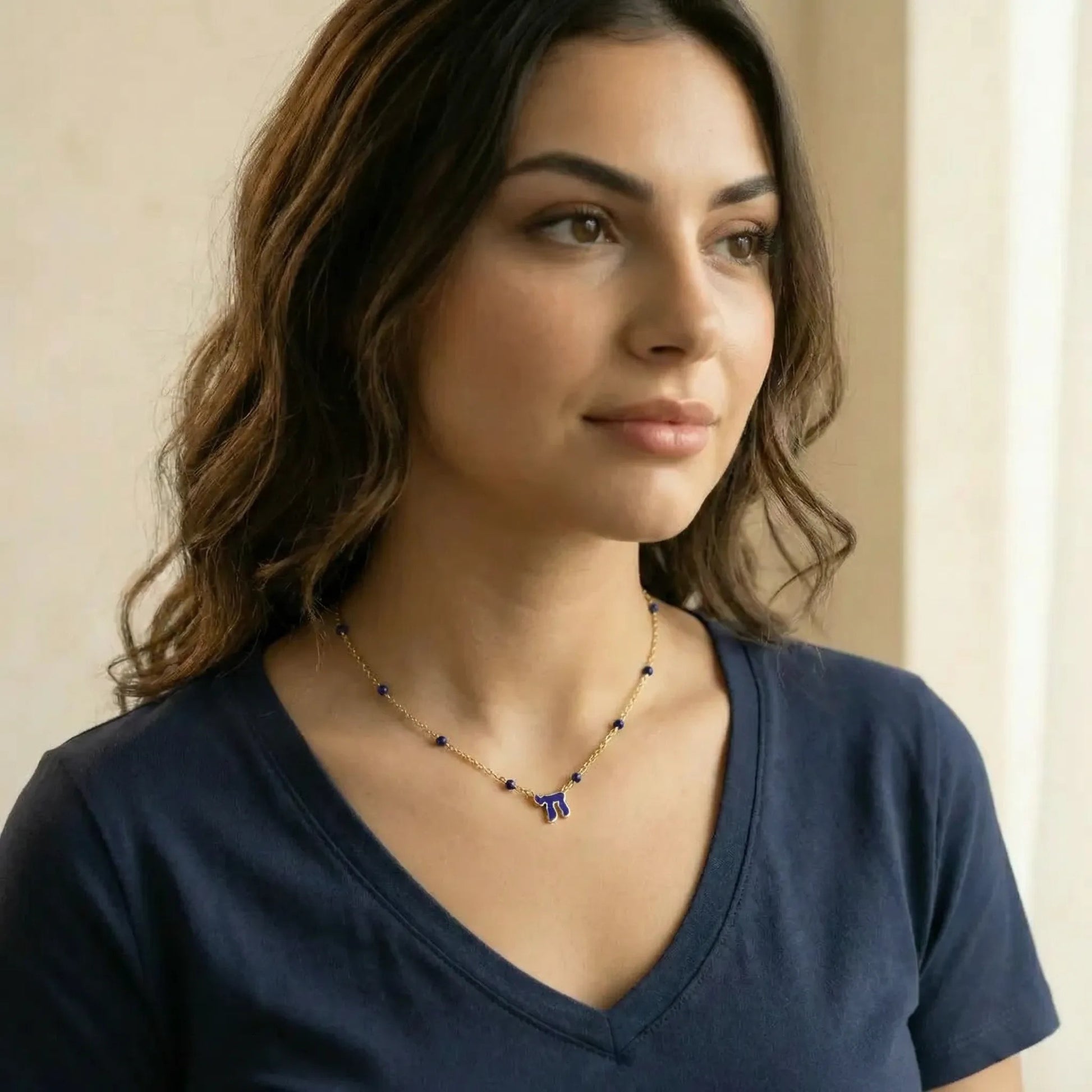 Beaded gold chain chai necklace in light blue enamel worn view by Alef Bet