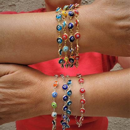 Colorful evil eye bracelets in gold or silver with multiple meanings; adjustable size, perfect for any wrist. Stylish and protective!