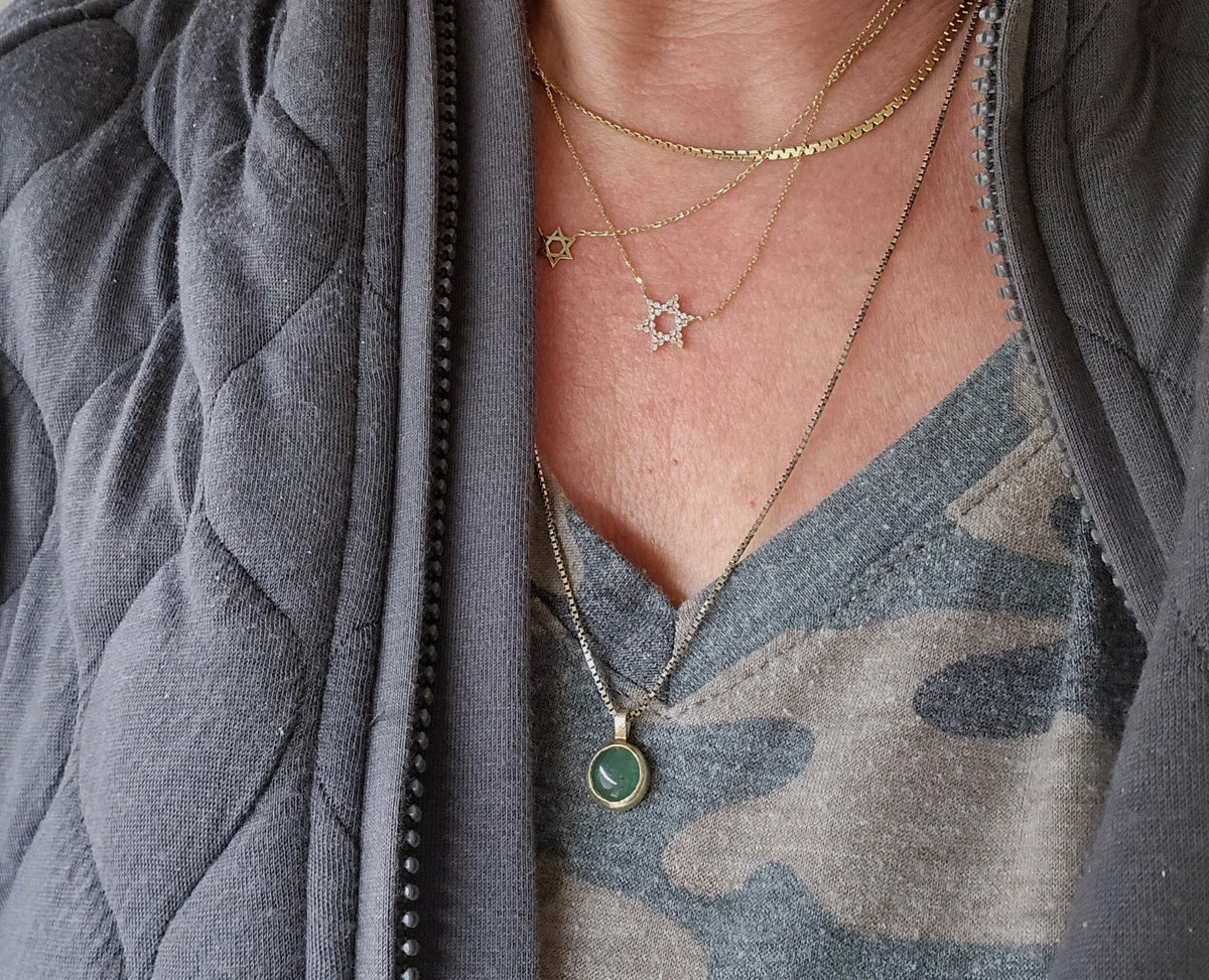 Star of David pendant in 14K white gold with bezel-set diamond by Alef Bet