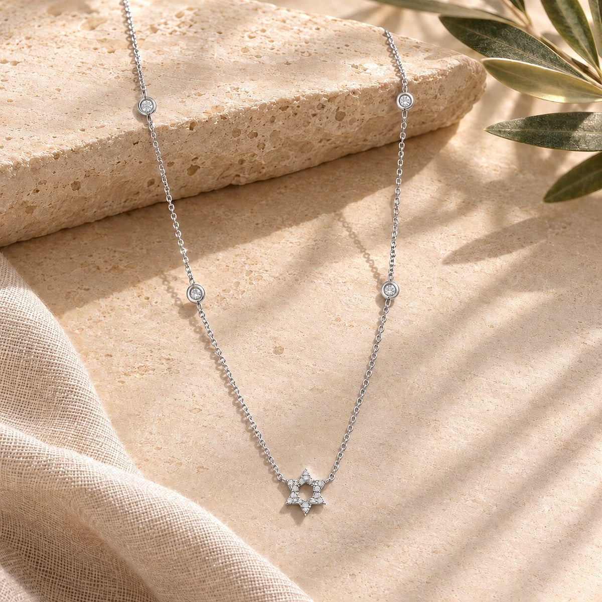 Diamond bezel Jewish star necklace in white gold with bezel-set diamond accents by Alef Bet