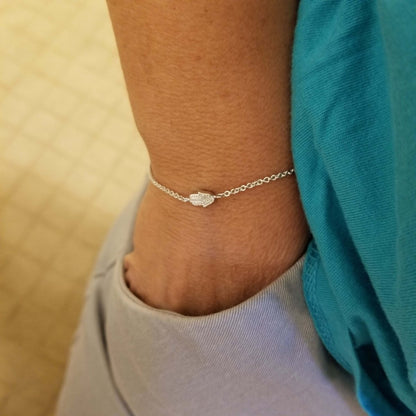 Diamond hamsa bracelet crafted in 14k gold or sterling silver, featuring .02 ct diamonds, adjustable for wrist sizes 6.5" to 7.5".