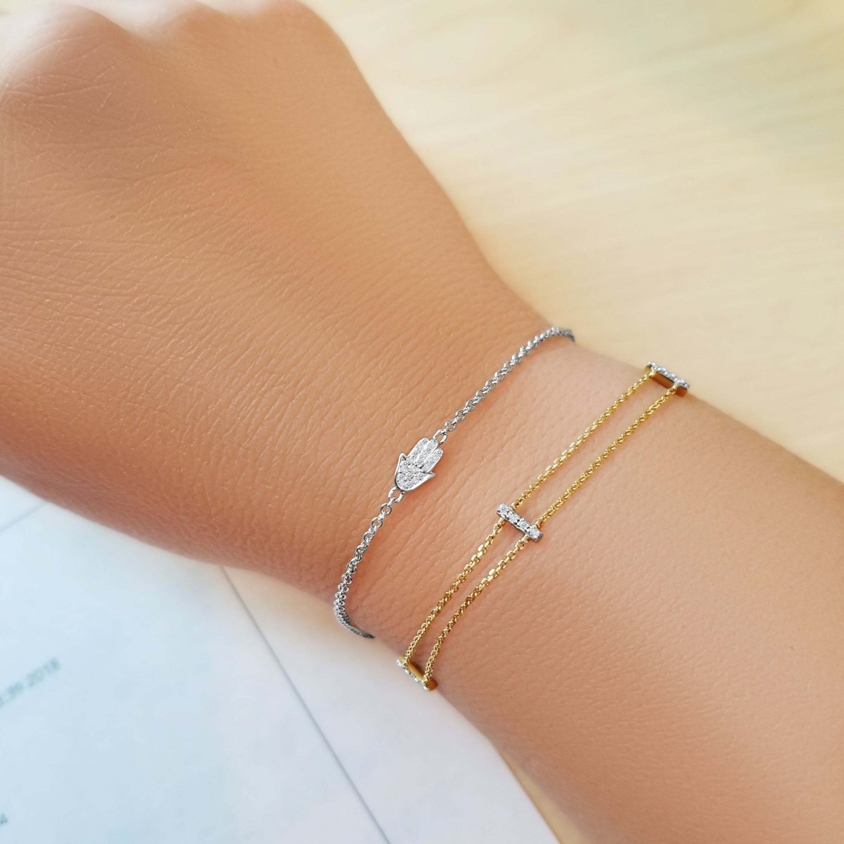 Diamond hamsa bracelet in 14k gold or sterling silver, adorned with .02 ct diamonds, adjustable 6.5" to 7.5" for a perfect fit.