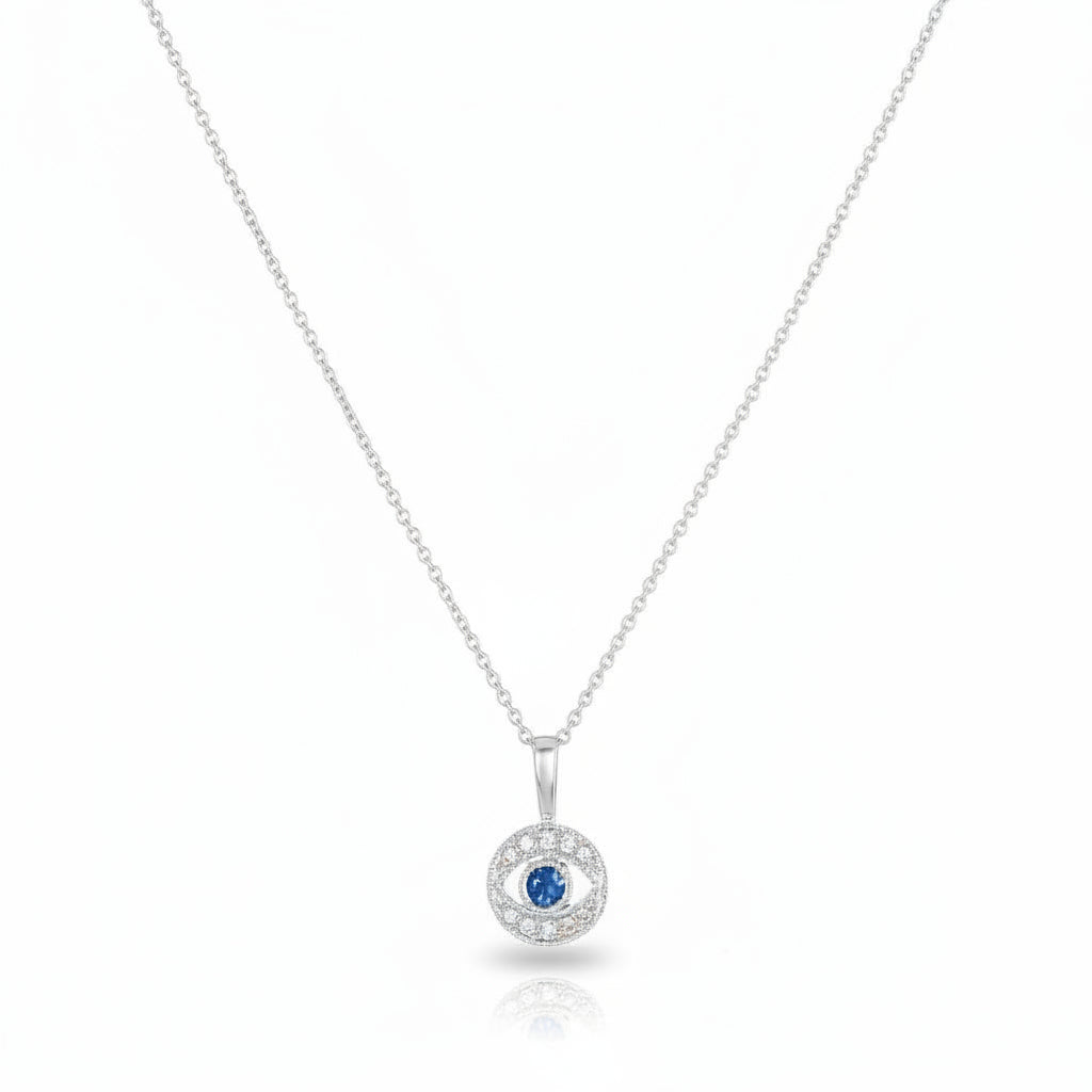 Diamond evil eye pendant in white gold with pave diamond surround and sapphire center by Alef Bet