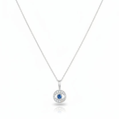 Diamond evil eye pendant in white gold with pave diamond surround and sapphire center by Alef Bet