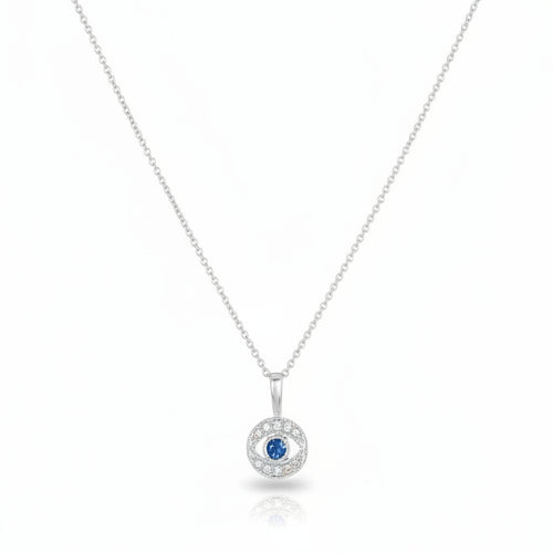 Diamond evil eye pendant in white gold with pave diamond surround and sapphire center by Alef Bet