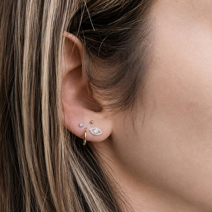 Evil eye hamsa diamond earrings in gold featuring bezel-set evil eye center by Alef Bet
