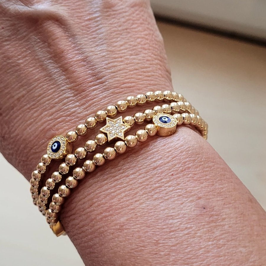 Evil eye bracelet in red with patterned beads and adjustable sizing by Alef Bet