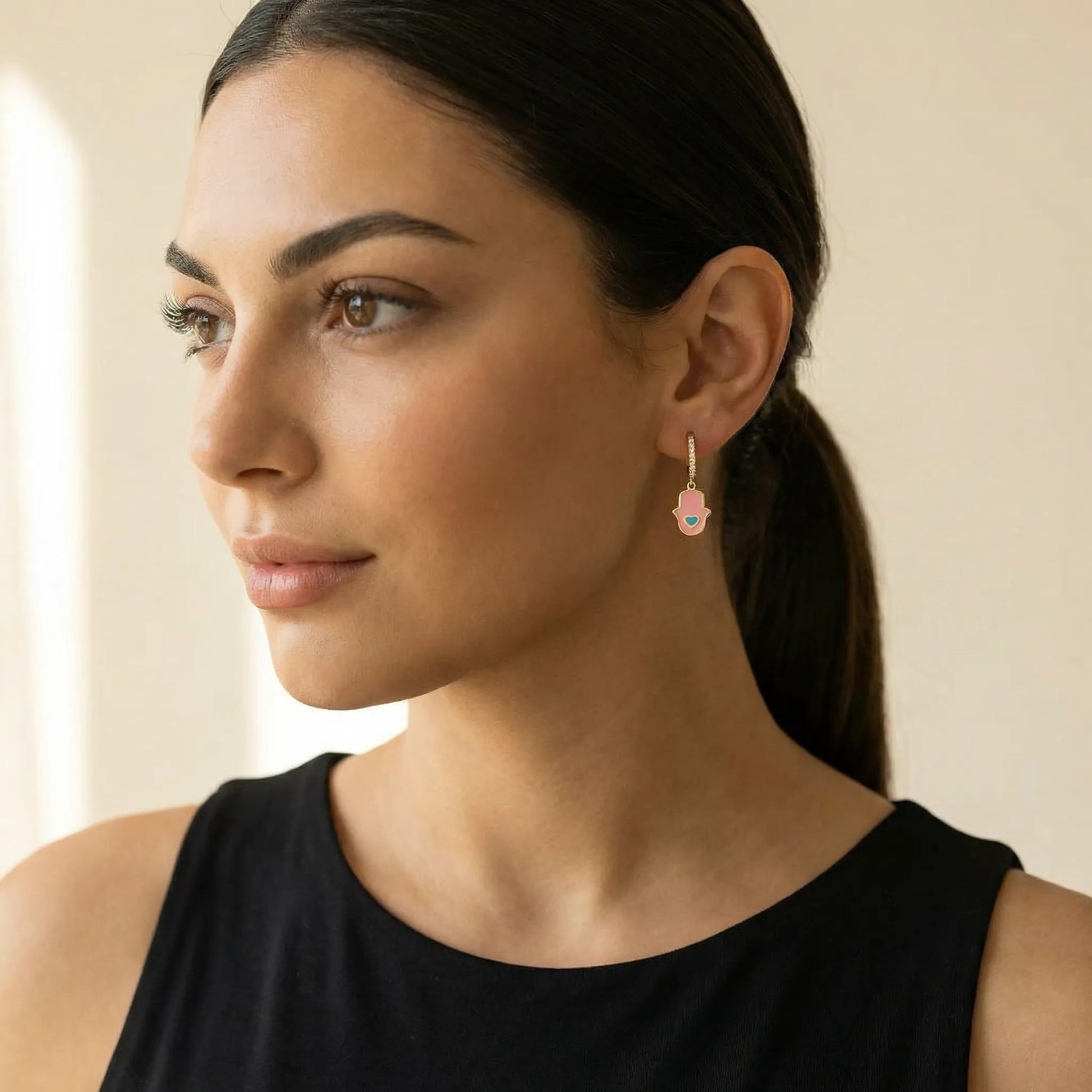Pink enamel hamsa charm huggie earrings featuring bezel-set CZ details by Alef Bet