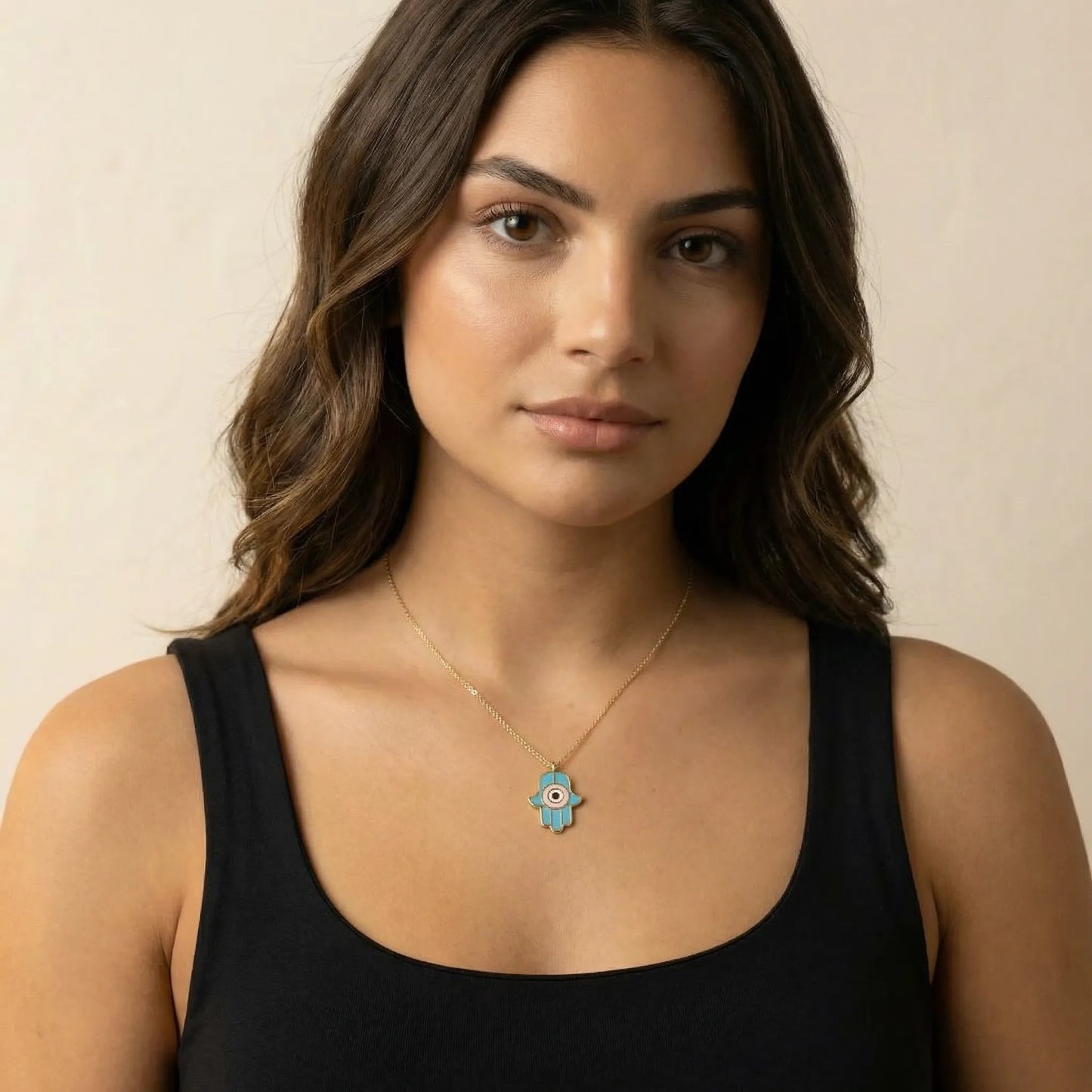 Gold hamsa pendant necklace featuring colorful enamel inlay and two-strand chain design