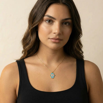 Gold hamsa pendant necklace featuring colorful enamel inlay and two-strand chain design