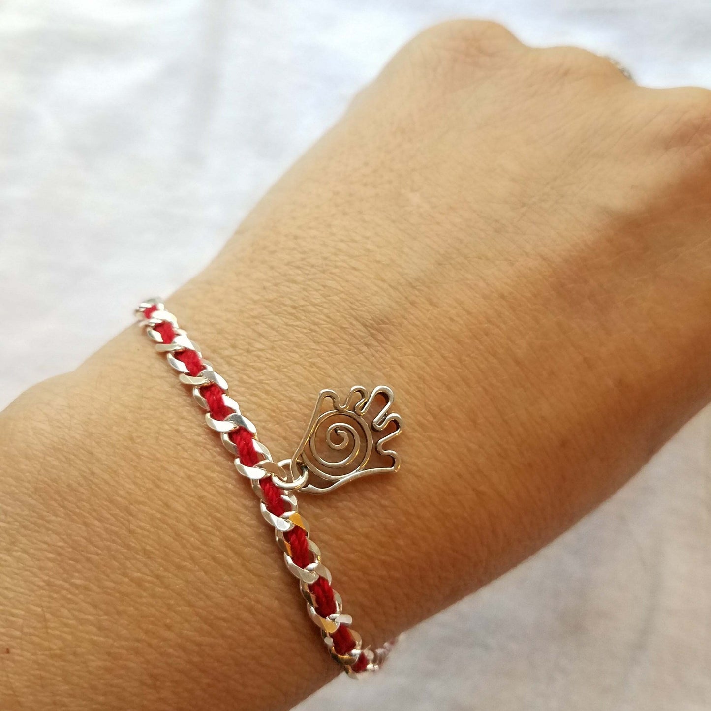 Hamsa infinity red string bracelet featuring a sterling silver pendant. A symbol of protection, happiness, and good fortune.