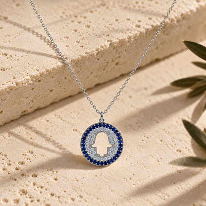 Silver hamsa pendant necklace featuring pave-set blue and white cubic zirconia by Alef Bet