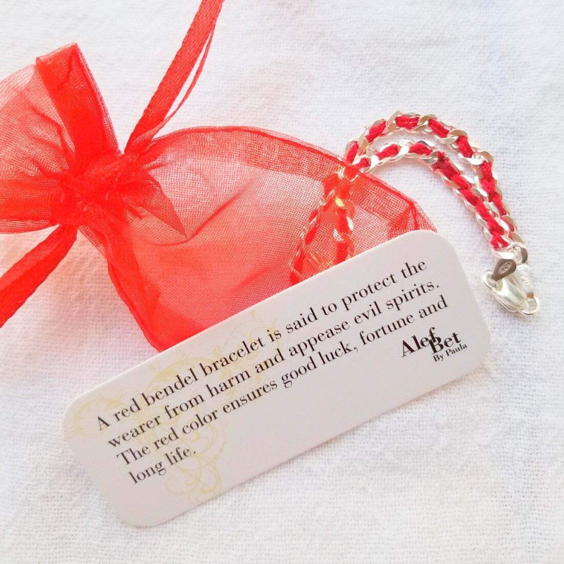 A Hamsa Red String Lucky Bracelet made of sterling silver, symbolizing protection, luck, and positive energy in a stylish design.