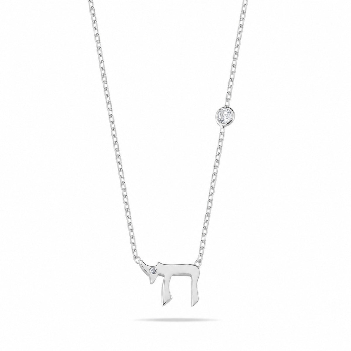 A silver chain necklace featuring a small donkey pendant with a tiny clear gemstone and a round bezel-set clear gemstone accent on the chain, shown against a plain white background.