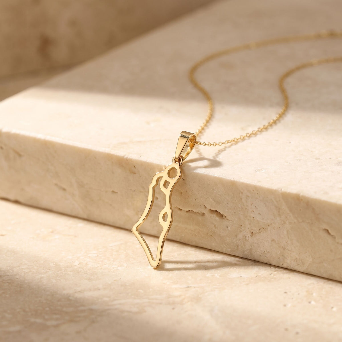 Gold Israel map pendant necklace showcasing engraved geographic borders by Alef Bet