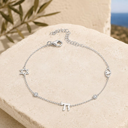 Sterling silver charm bracelet with star and evil eye charms, full display by Alef Bet