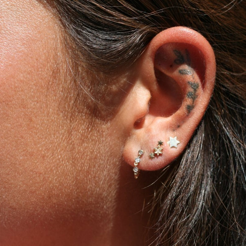14k gold Jewish star earrings showcasing six-point star design from side angle by Alef Bet
