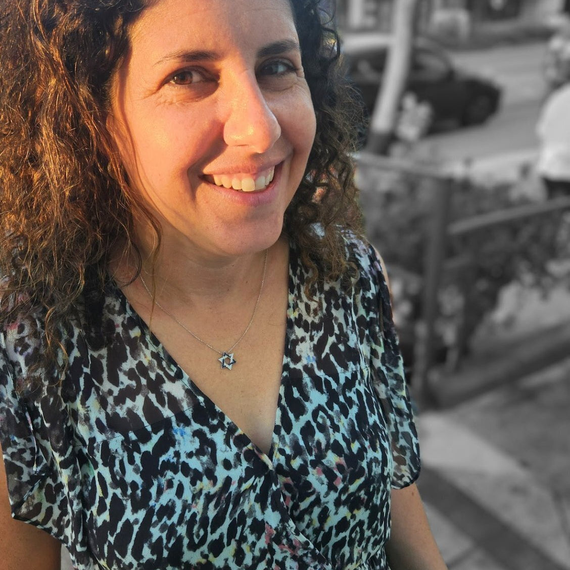 Gold-plated Star of David necklace with blue and white cubic zirconia, representing the Israeli flag; adjustable chain included.