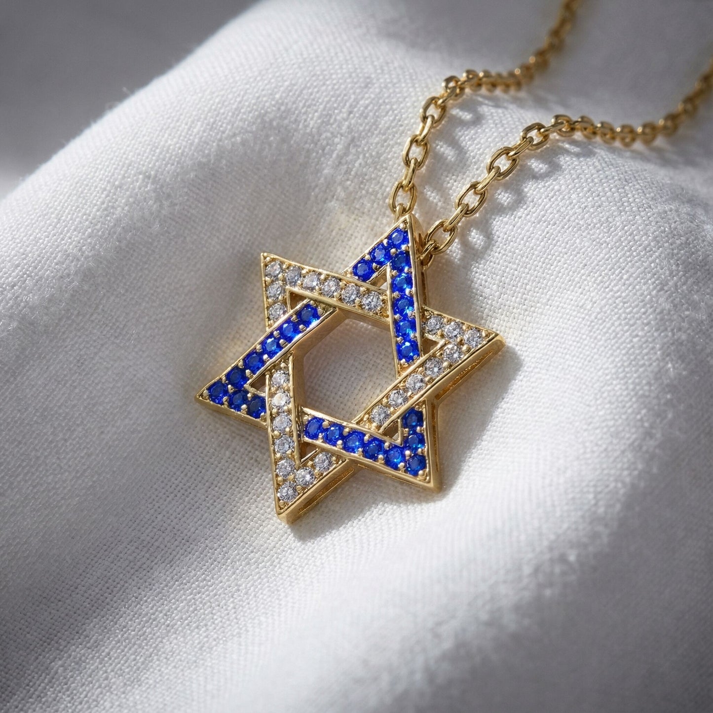 Israel Flag Jewish Star necklace featuring a gold-plated silver pendant with blue and white cubic zirconia, symbolizing pride and identity.