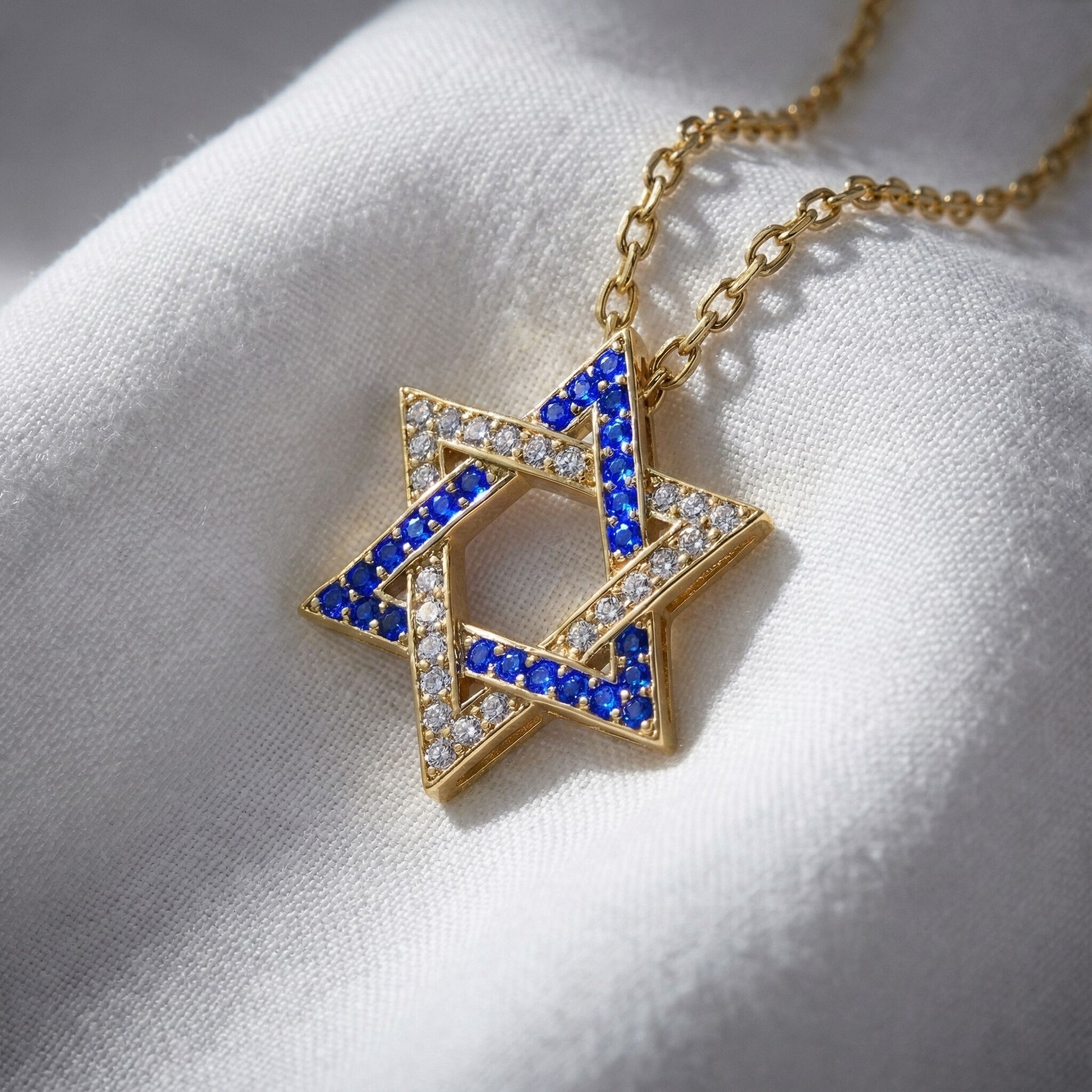 Israel Flag Jewish Star necklace featuring a gold-plated silver pendant with blue and white cubic zirconia, symbolizing pride and identity.