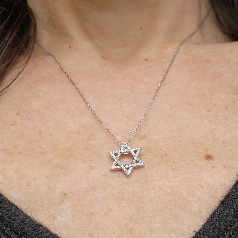 Star necklace in yellow gold with pave-set diamond accents by Alef Bet