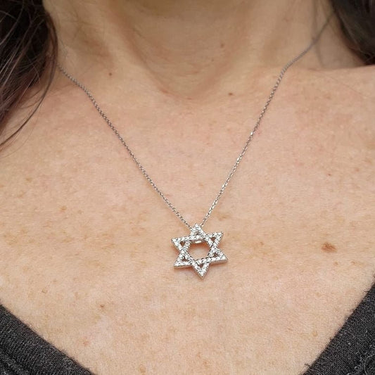 Star necklace in yellow gold with pave-set diamond accents by Alef Bet