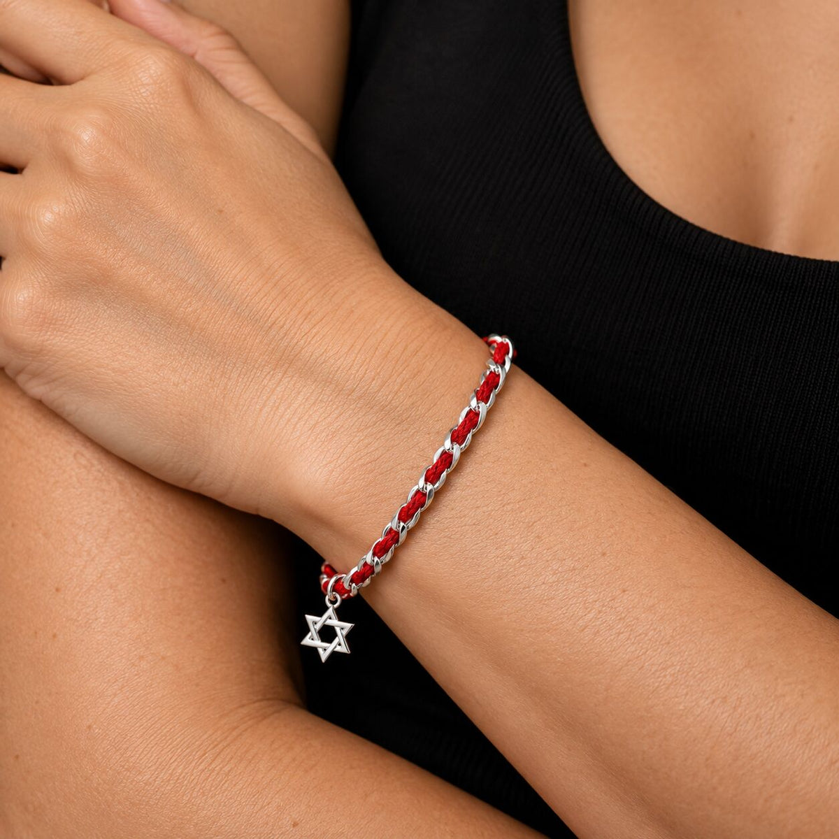 A red string of fate bracelet featuring the Star of David charm, symbolizing protection and faith in Jewish tradition.