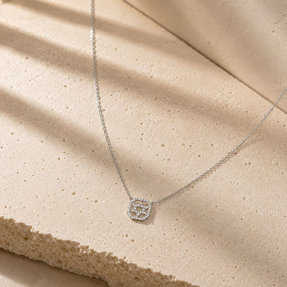 Pave diamond Star of David necklace in 14k white gold showcasing geometric square frame design