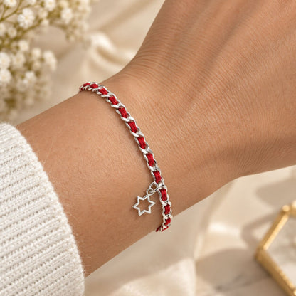 Red string bracelet featuring a Star of David, symbolizing protection and faith, made with sterling silver and includes a description card.