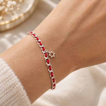 Red string bracelet featuring a Star of David in sterling silver, symbolizing faith, protection, and guidance; includes a description card.