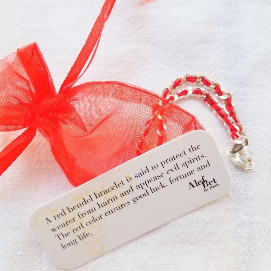 Silver bracelet featuring a Jewish star charm on a red string, symbolizing luck and protection, ideal for special gifts.
