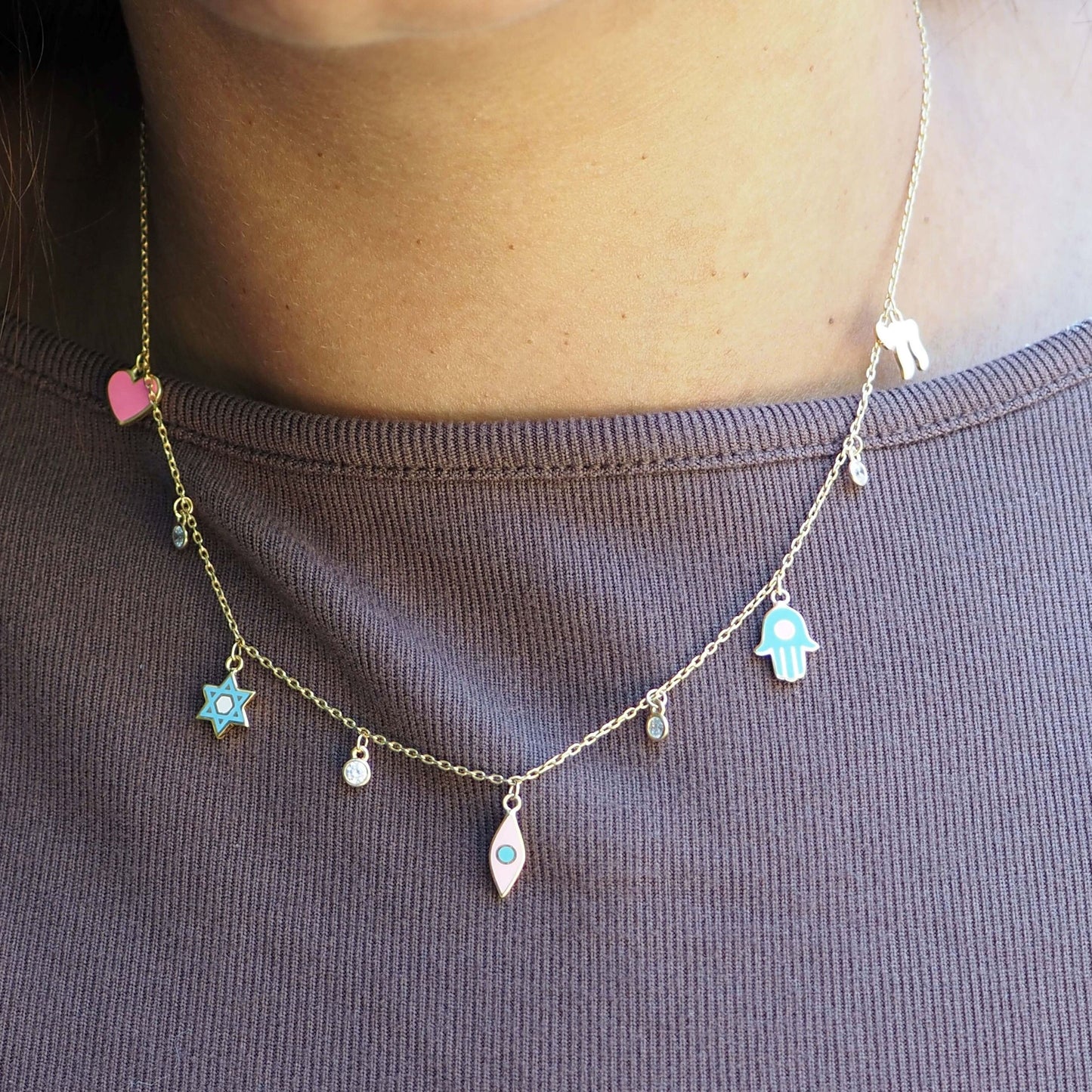 Layering necklace in gold with five hanging charms hamsa star chai and symbolic pendants by Alef Bet