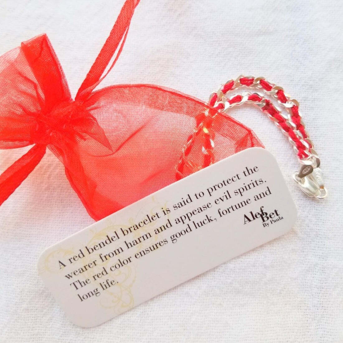 Red string bracelet featuring a sterling silver Star of David pendant, symbolizing guidance and protection, gift wrapped with a meaning card.