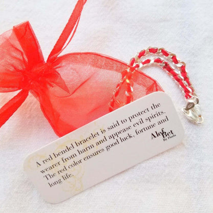Red string bracelet featuring a sterling silver Star of David pendant, symbolizing guidance and protection, gift wrapped with a meaning card.